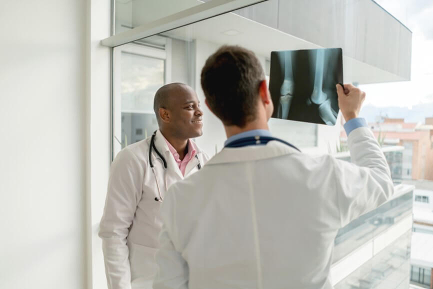 Two doctors examining a knee xray