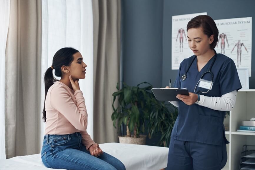 Woman and doctor in clinic talking