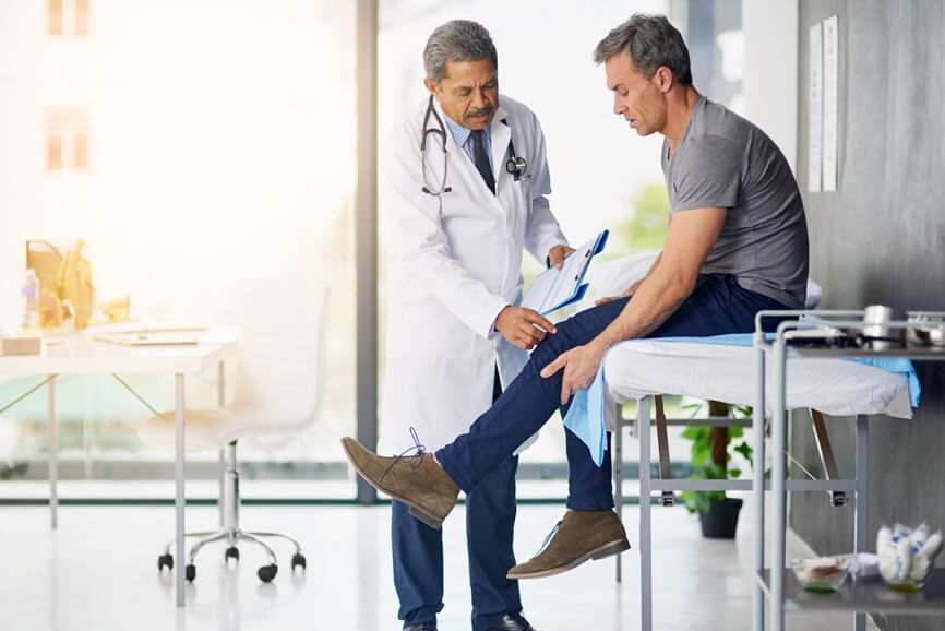 doctor examining patient's knee