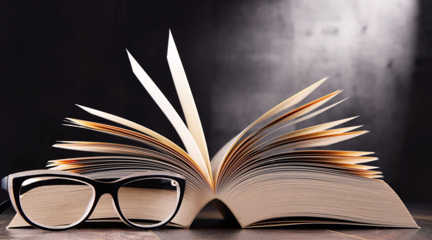 reading glasses in front of an open book