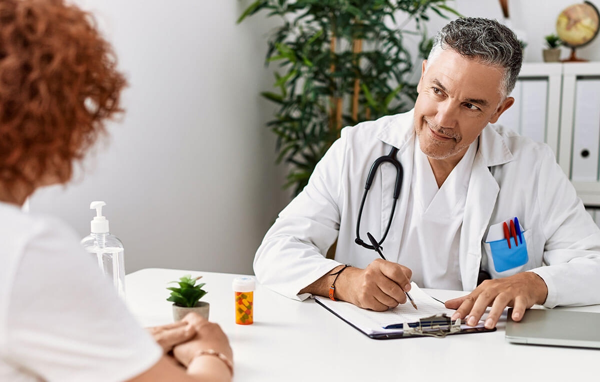 Doctor talking to patient at desk