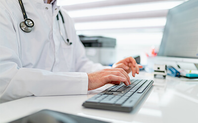 healthcare professional tying on keyboard
