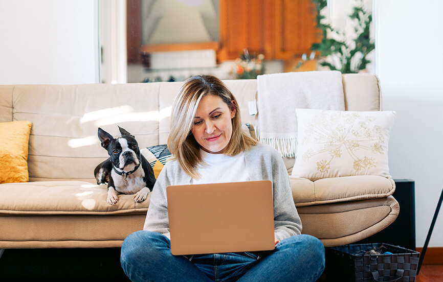 woman on the couch taking a survey on her computer