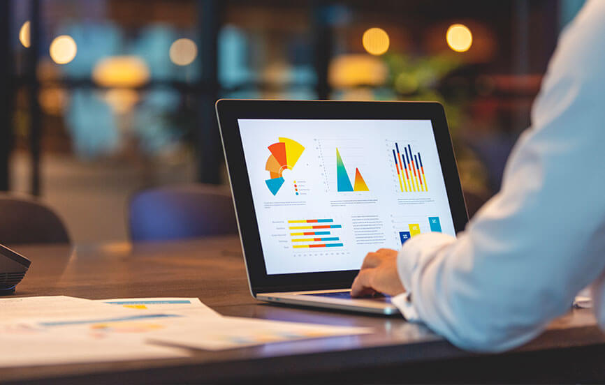 person on computer looking at graphs