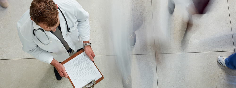 joint replacement surgeon walking through busy medical office