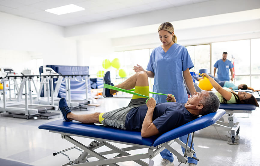 Man doing physical therapy exercises using a stretch band