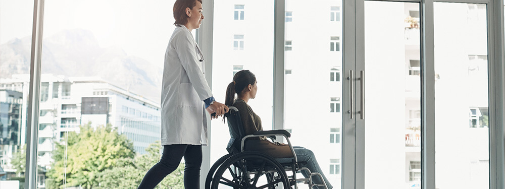 healthcare professional walking a patient to the exit door post-discharge