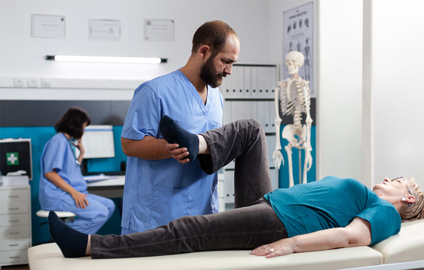 Healthcare Professional stretching a patient's knee