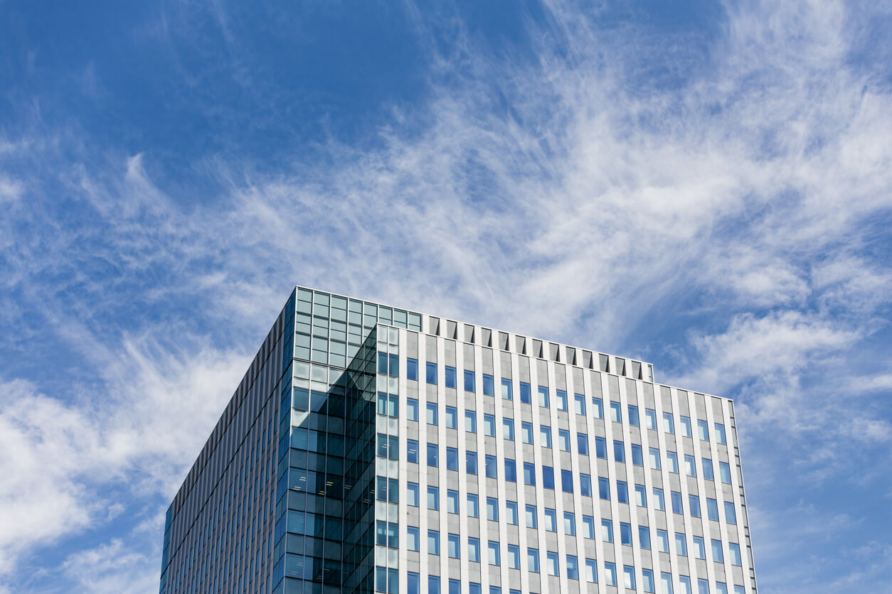 Modern building facade with rectangle and square windows form with clear blue sky with cloud in Sapporo at Hokkaido, Japan.